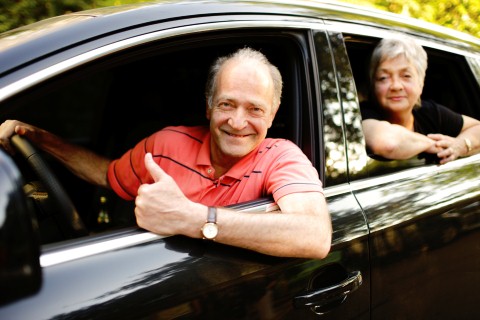 Happy Senior Couple travelling in their car
